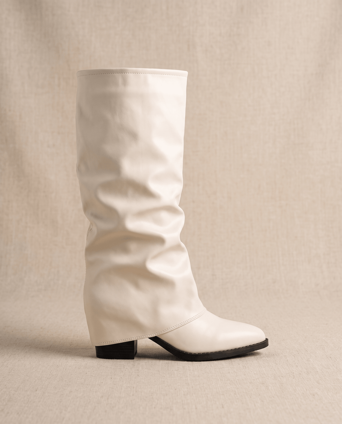 Single cream boot in side profile showing the fold-over shaft and block heel