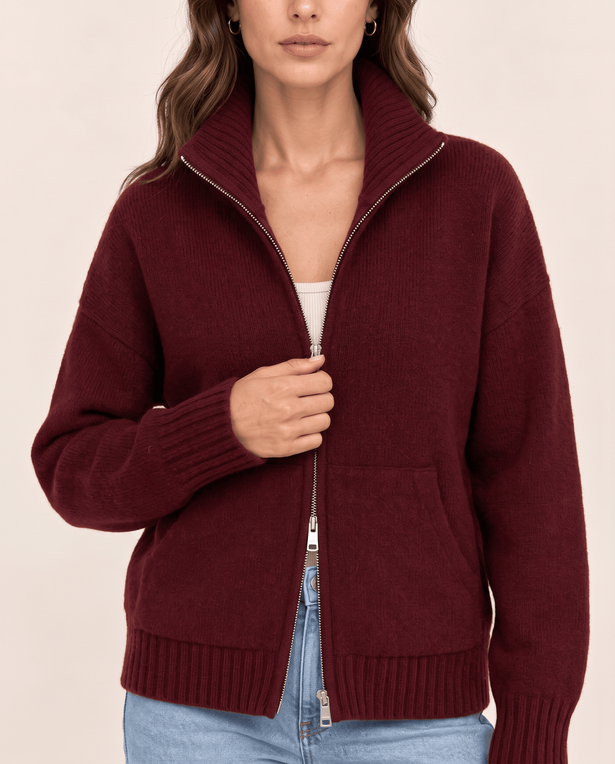 Close-up of wine red knit with full-length zip and ribbed trim