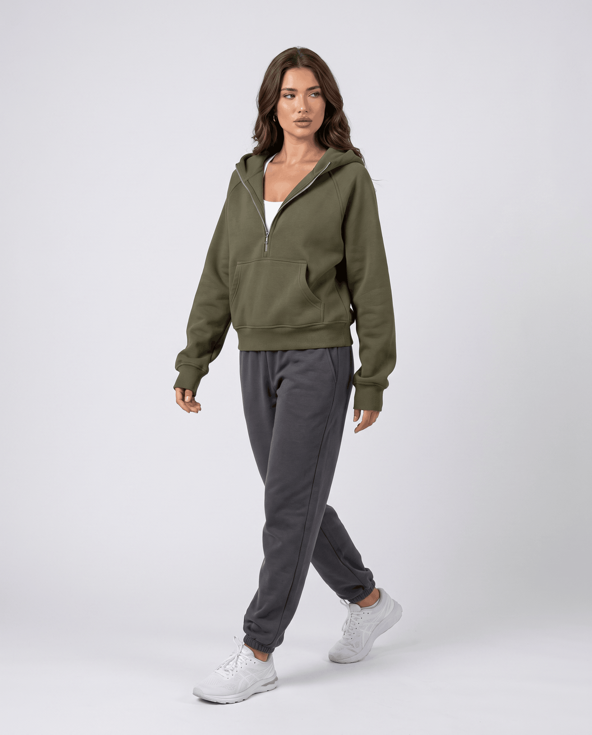 Full-length look styling the green half zip hoodie with gray joggers and white sneakers