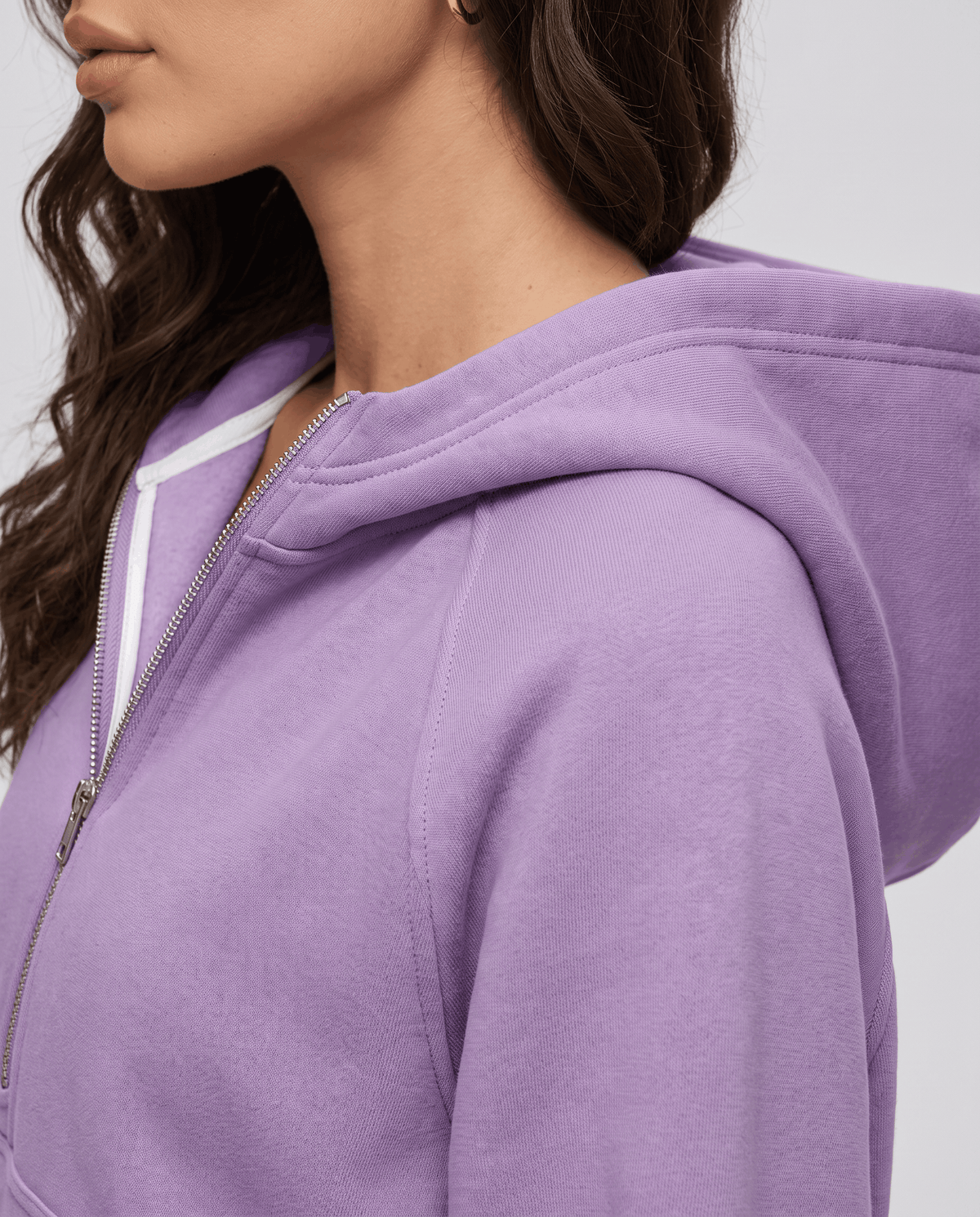 Side close-up of the purple hood and soft textured fleece beside the zipper