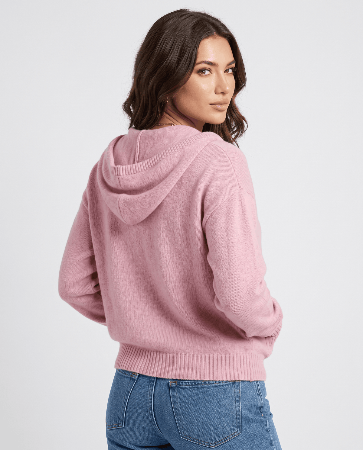 Back of light pink knit cardigan with the hood down and an oversized shape