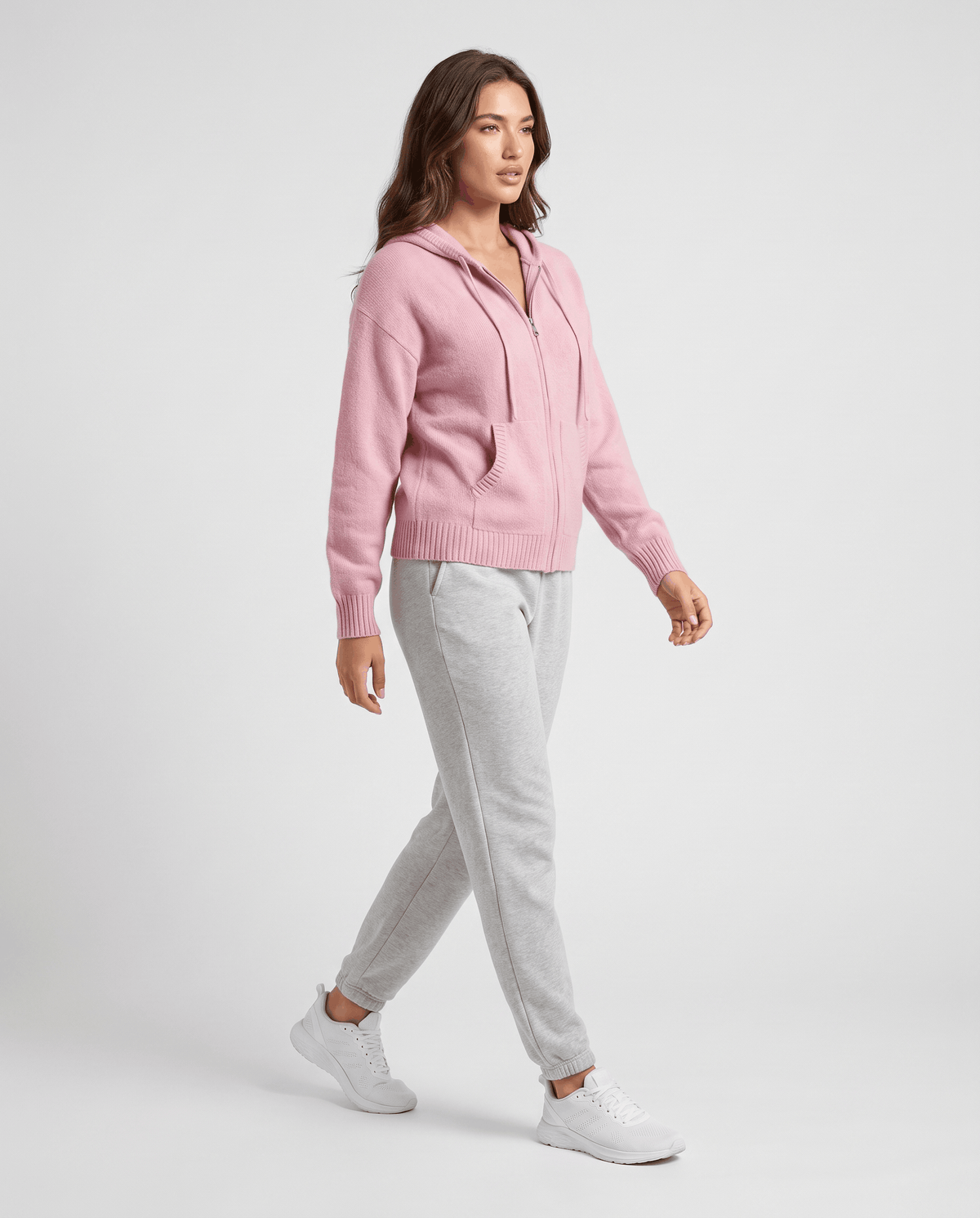 Full-length light pink zip-up cardigan worn with gray joggers and white sneakers