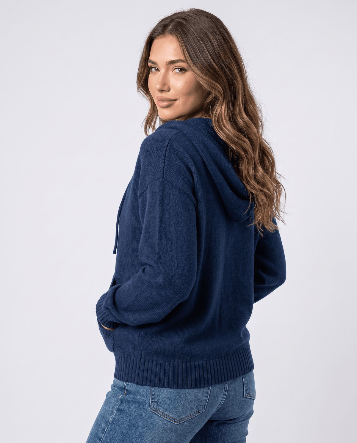 Navy blue cardigan seen from behind and side with the hood down and soft knit sleeves