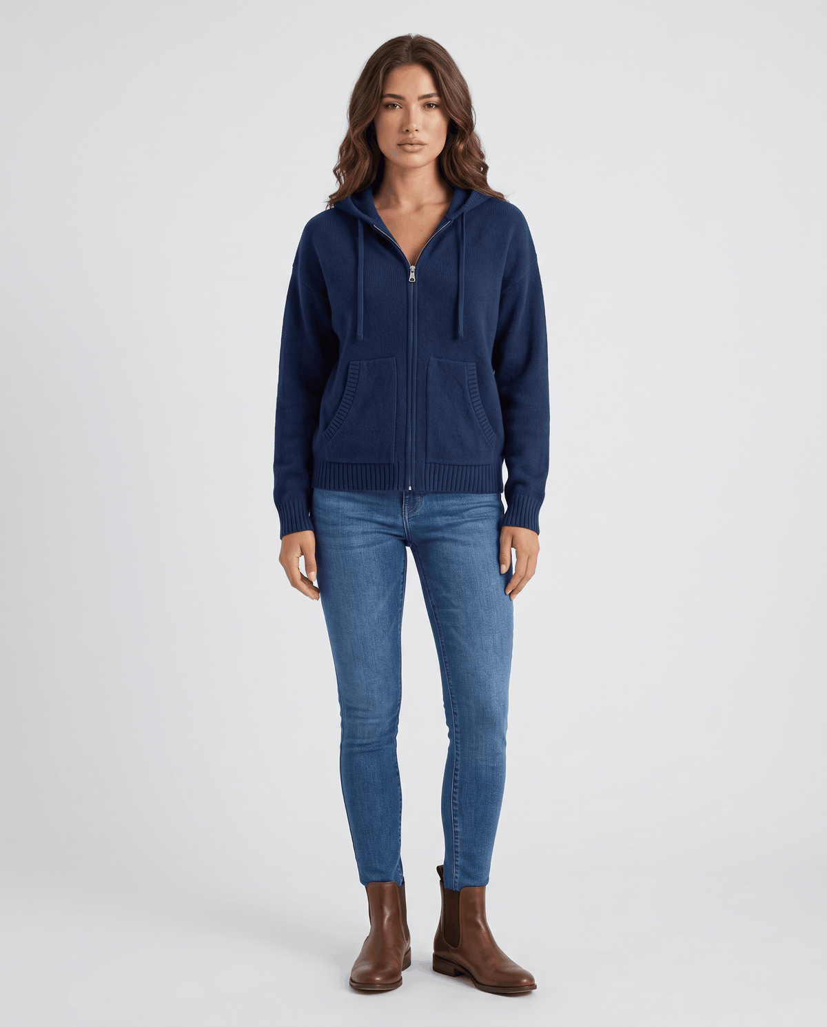 Full-length navy blue hooded cardigan styled with blue jeans and brown boots