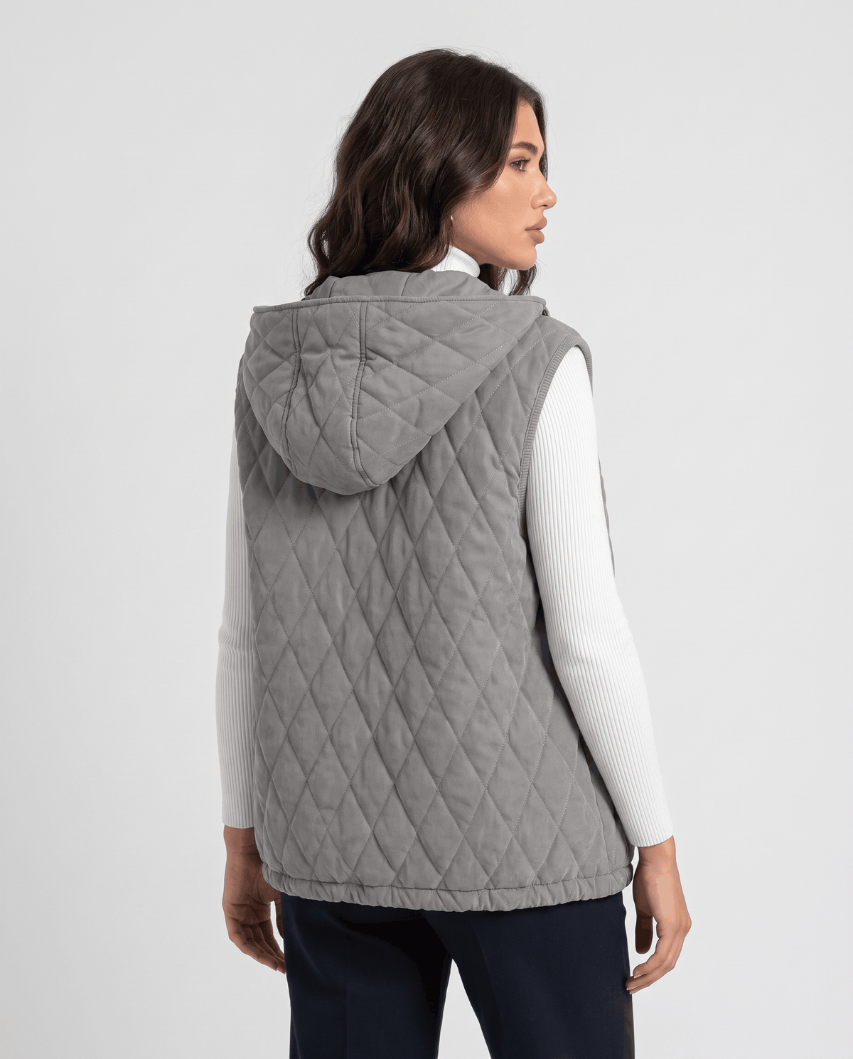 Back view of gray hooded quilted puffer vest with diamond stitching