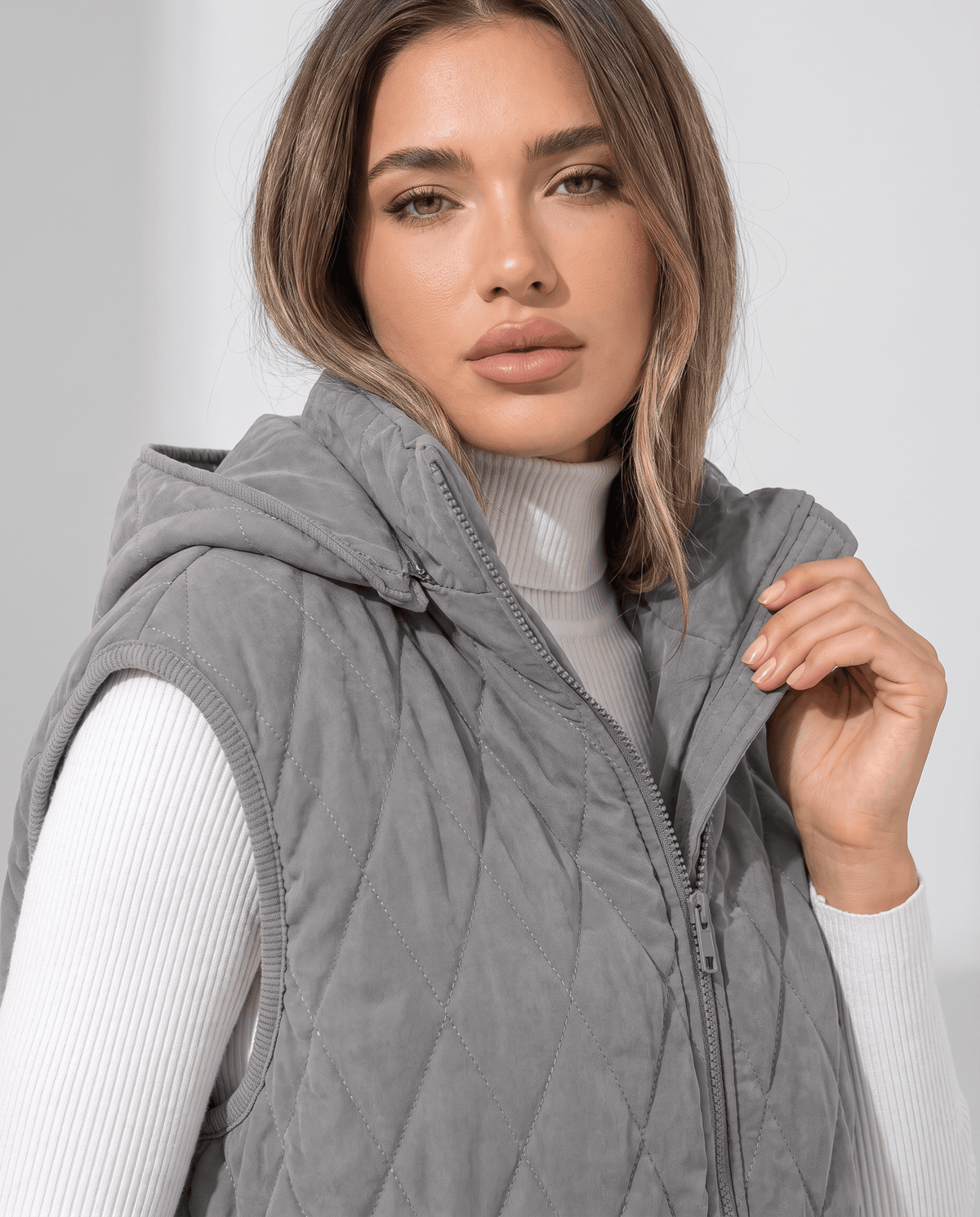 Gray quilted vest zip front and hood shown in close view