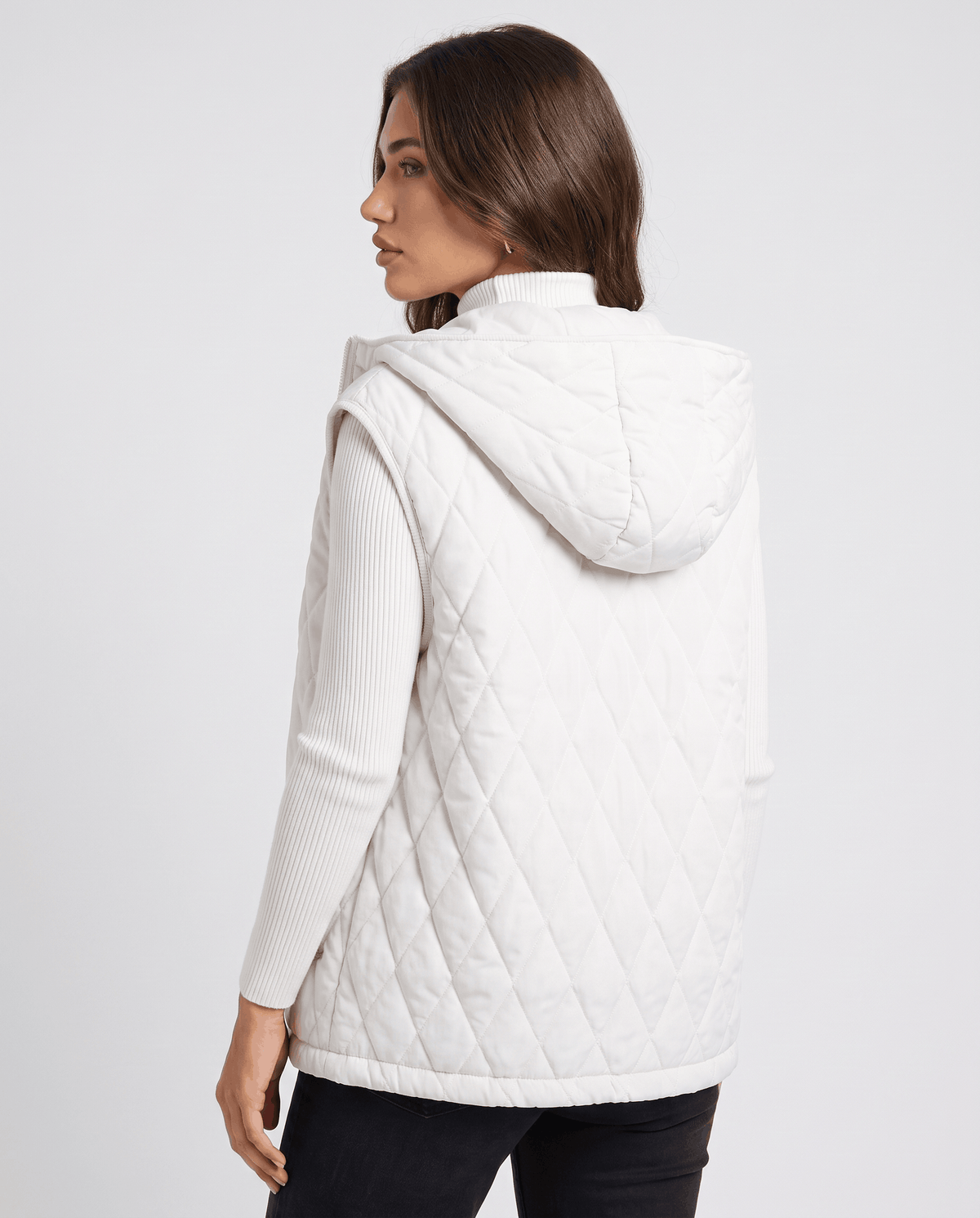 Back view of white hooded quilted vest on a model