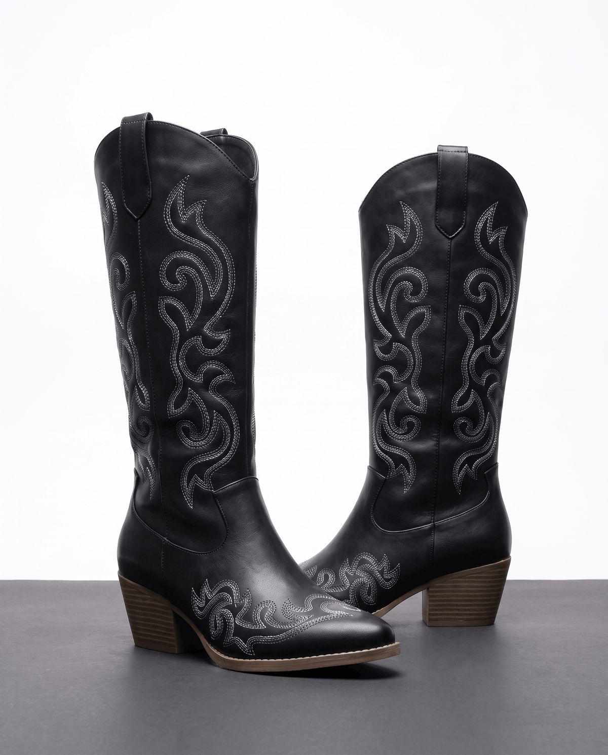 Black pair on a white display block with pointed toes and pull tabs