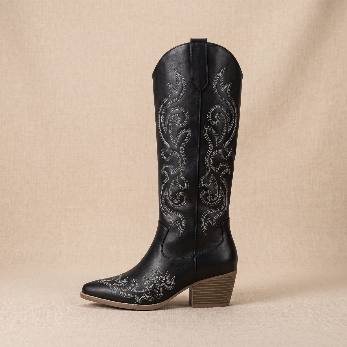 Single black boot in side profile showing gray contrast embroidery