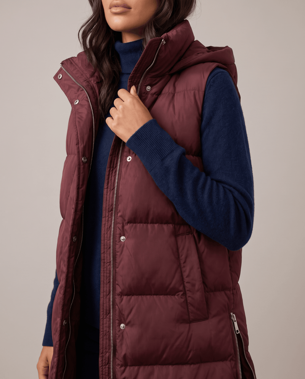 Burgundy quilted vest front placket and hood shown in close view