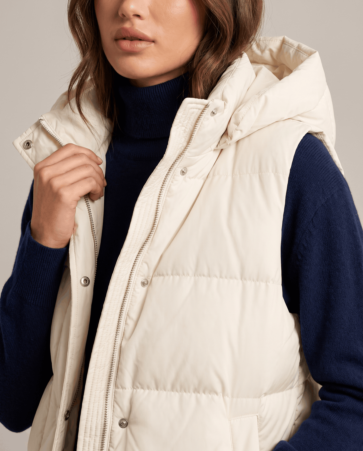 Cream quilted vest front placket and hood shown in close view