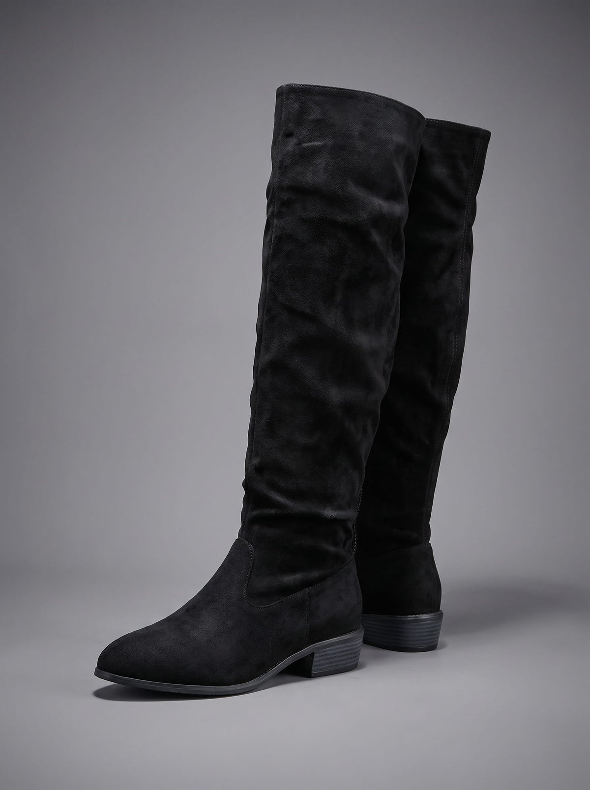 Black boot angled to show the gathered ankle and pointed toe