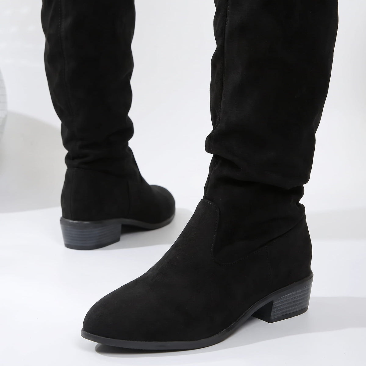 Close-up of the black pointed toe, slouched ankle and stacked block heel
