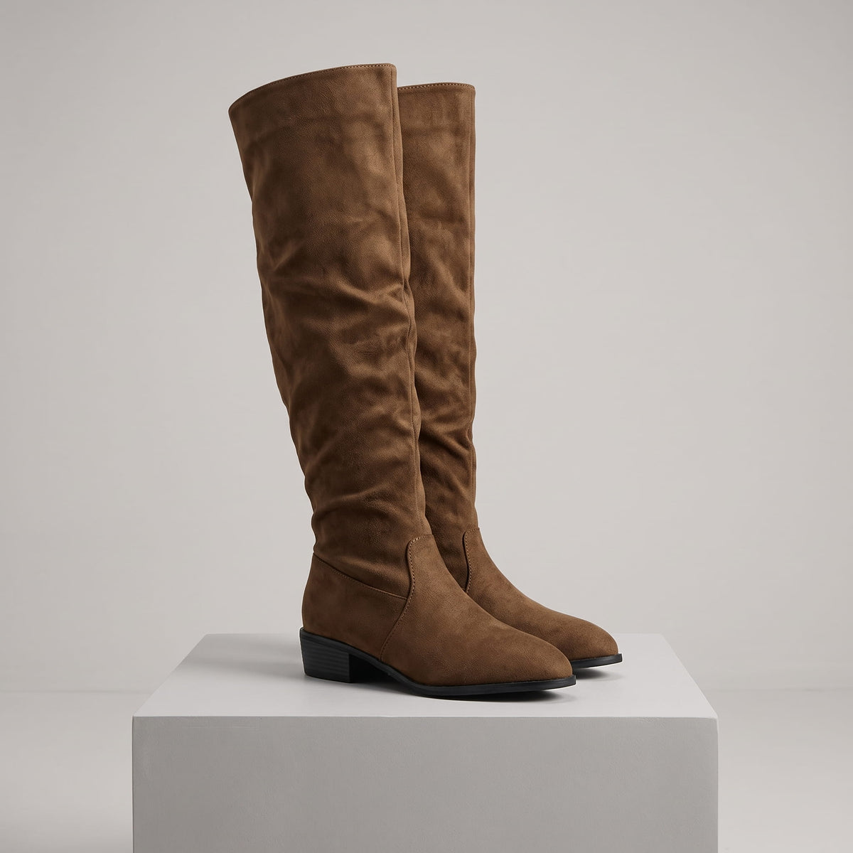 Olive brown pair on a white display block showing the tall soft shaft