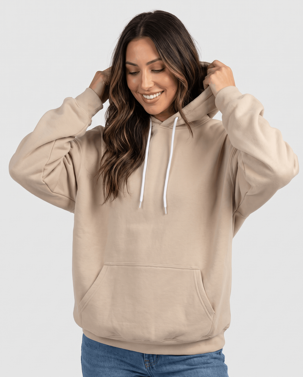 Khaki hoodie worn with the hood up and jeans, front view