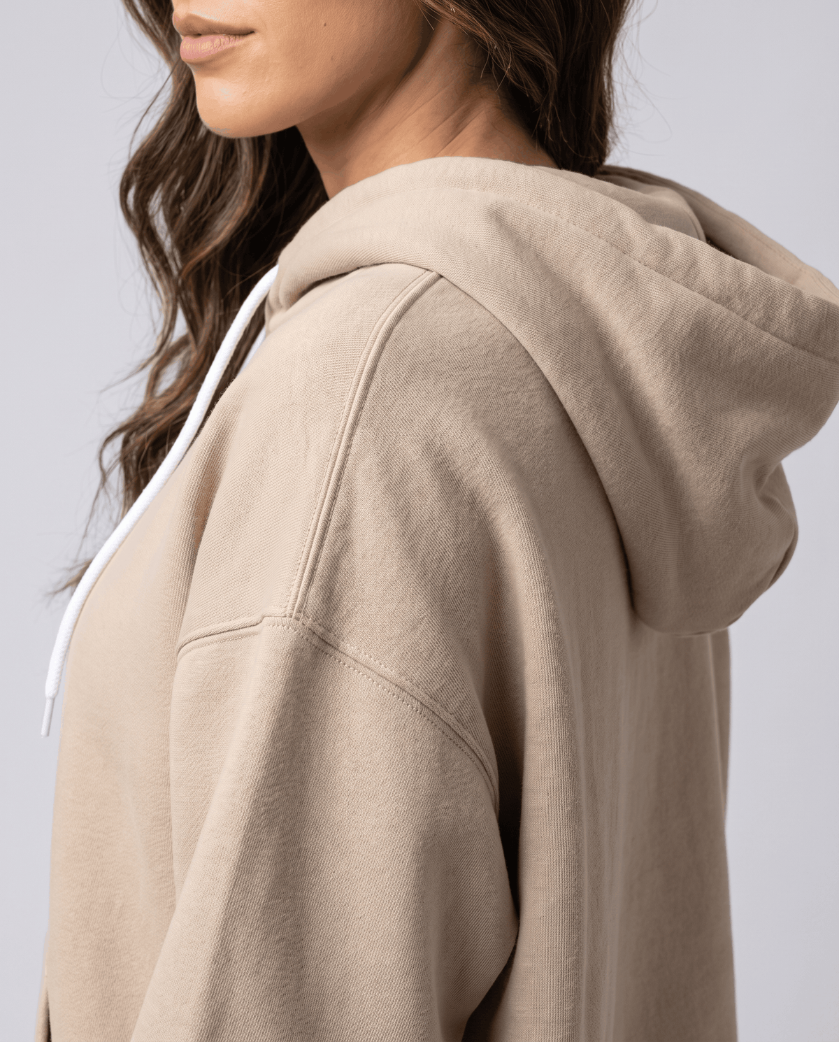 Side close-up of the khaki hood and dropped shoulder on the thick fabric