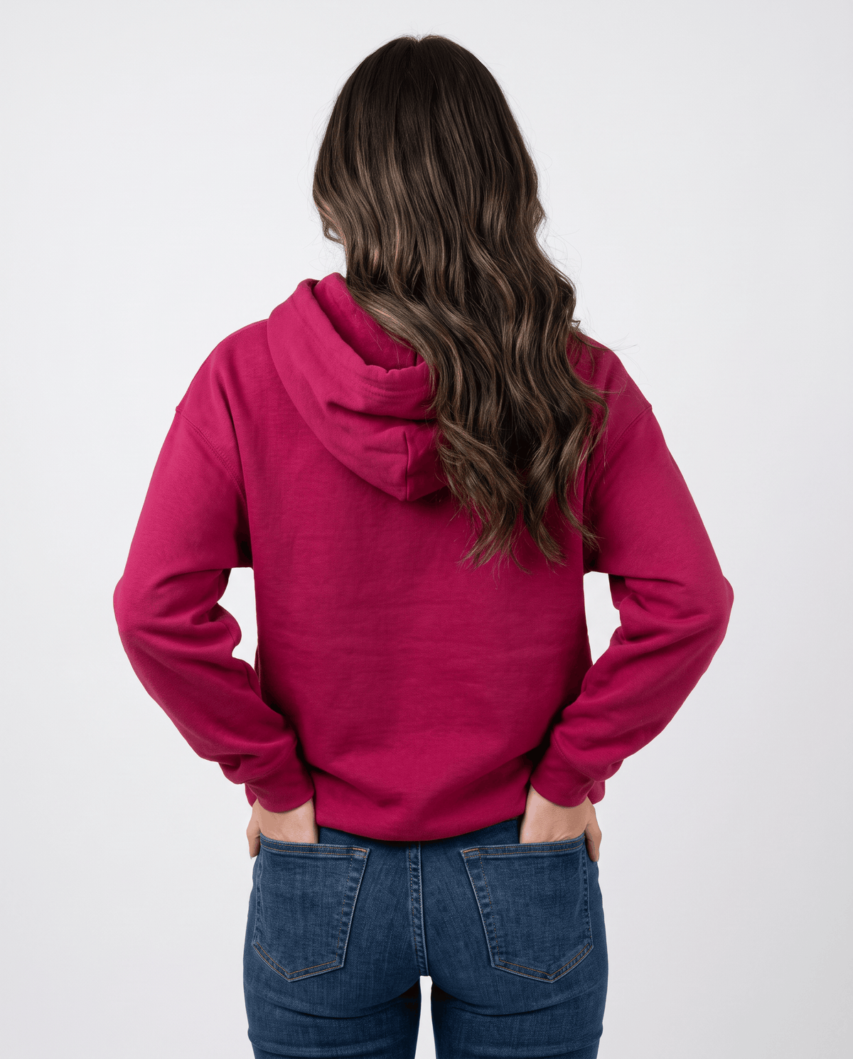 Back view of the red hoodie with hands in jeans pockets and the hood down