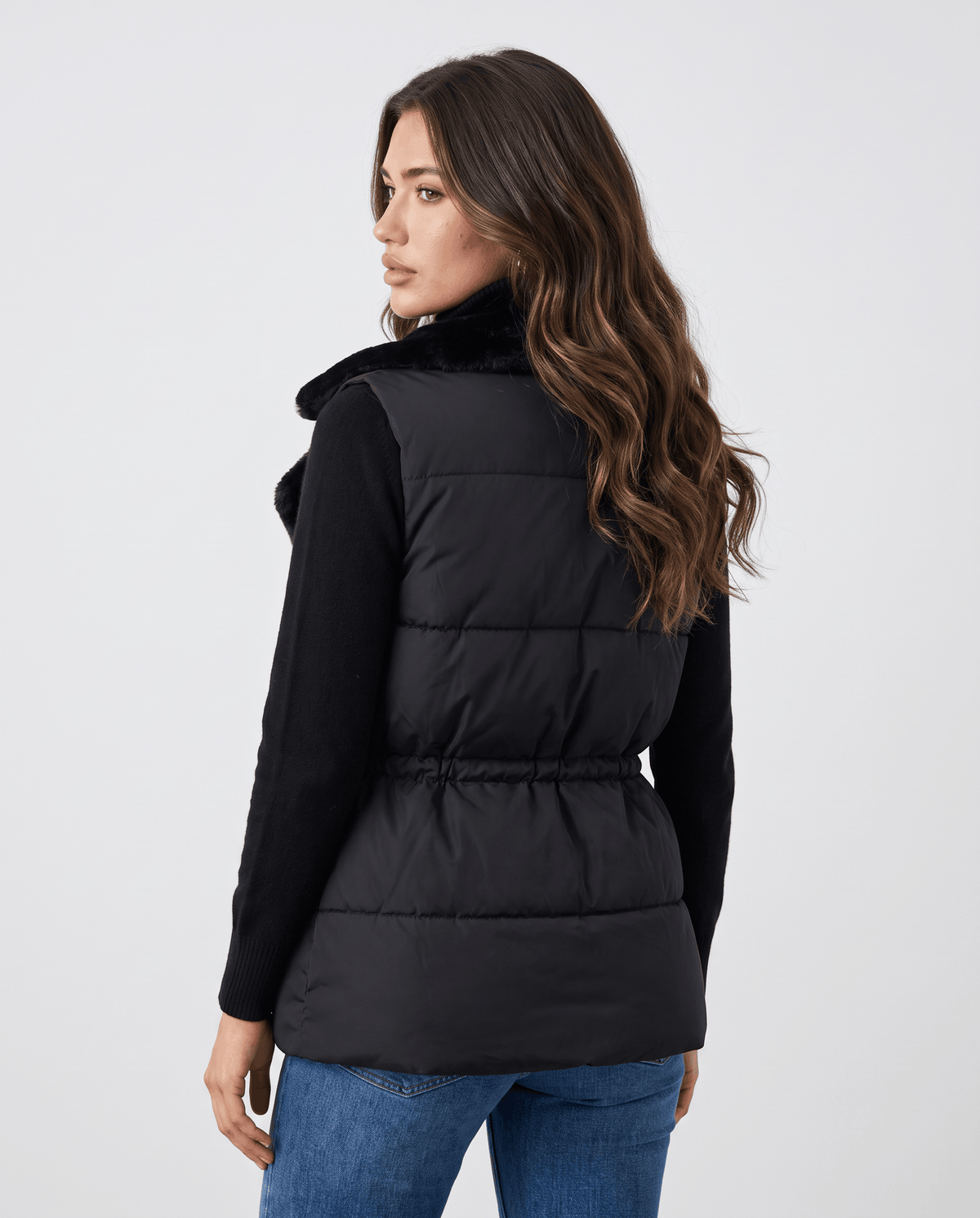 Back view of black padded vest with cinched drawstring waist