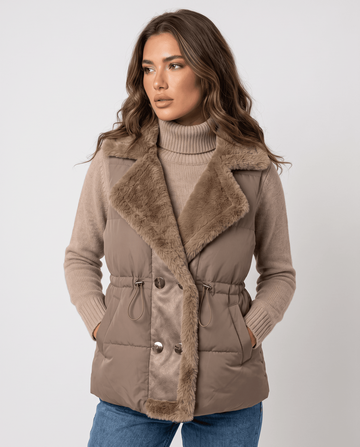 Women's khaki padded vest with plush collar and drawstring waist worn with jeans