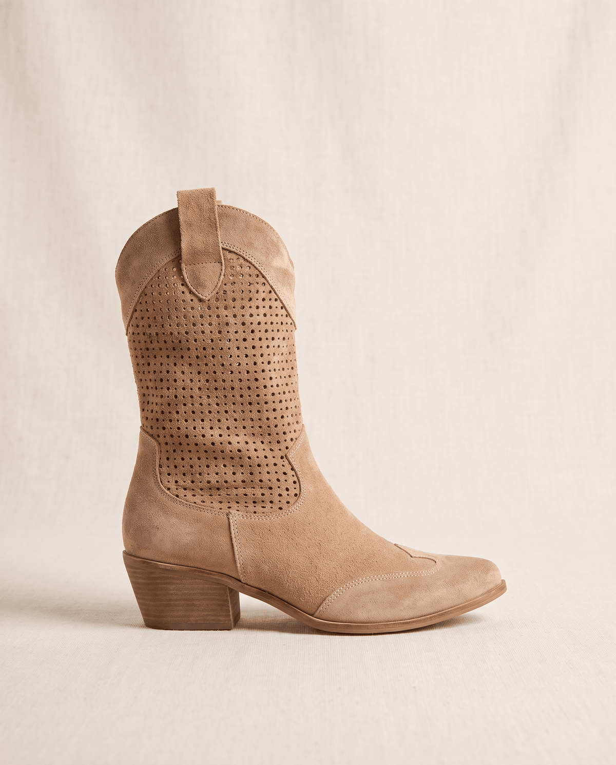 Single brown boot in side profile showing the laser-cut shaft pattern