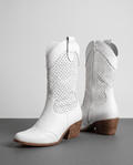 Pair of white perforated cowboy boots with pointed toes, inside zip and stacked heels