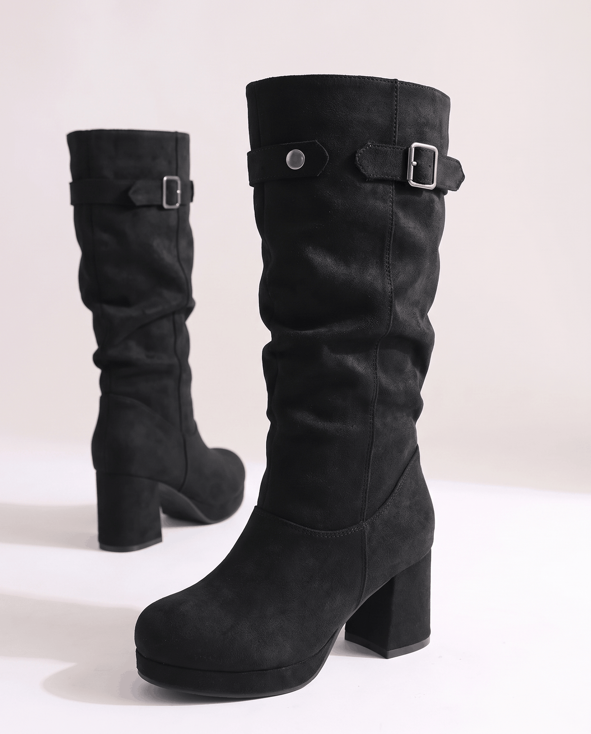 Black pair angled to show the slouched shaft and rounded toe