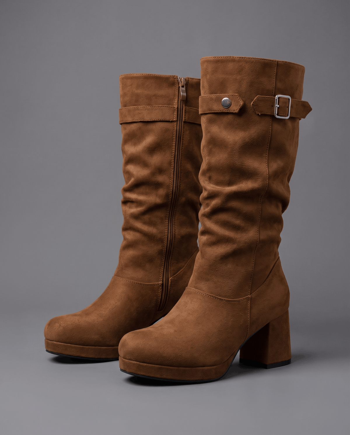 Brown boots on a gray floor showing the full-length inside zip
