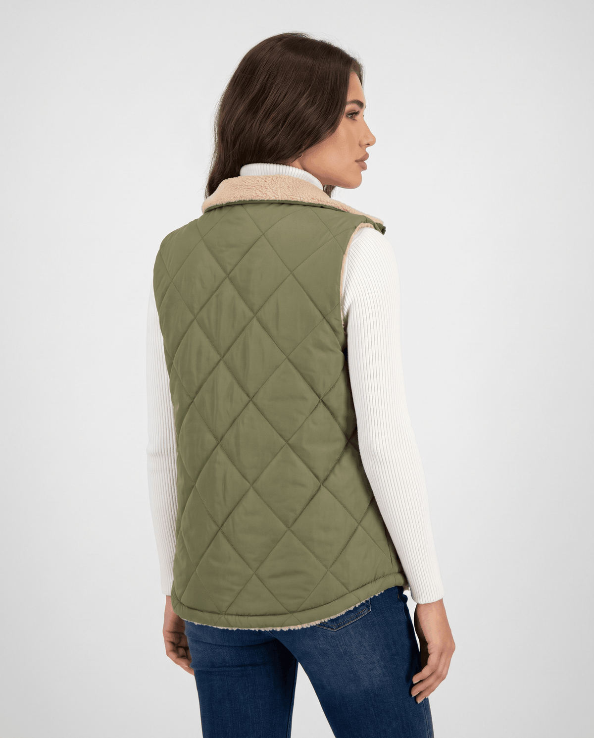 Back view of green diamond-quilted vest on a model