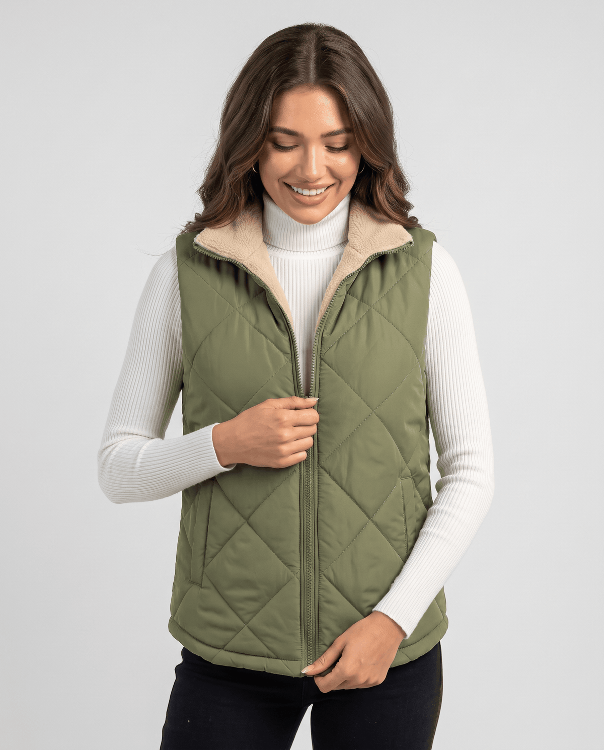Green quilted vest with full zip front worn over a white turtleneck