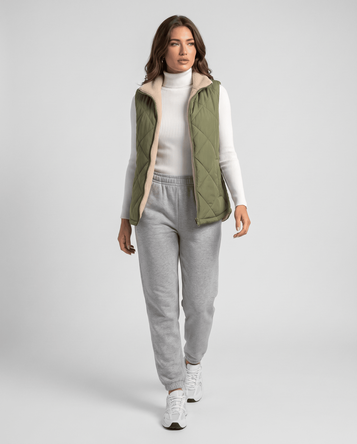 Full-length view of green quilted vest styled with a light top