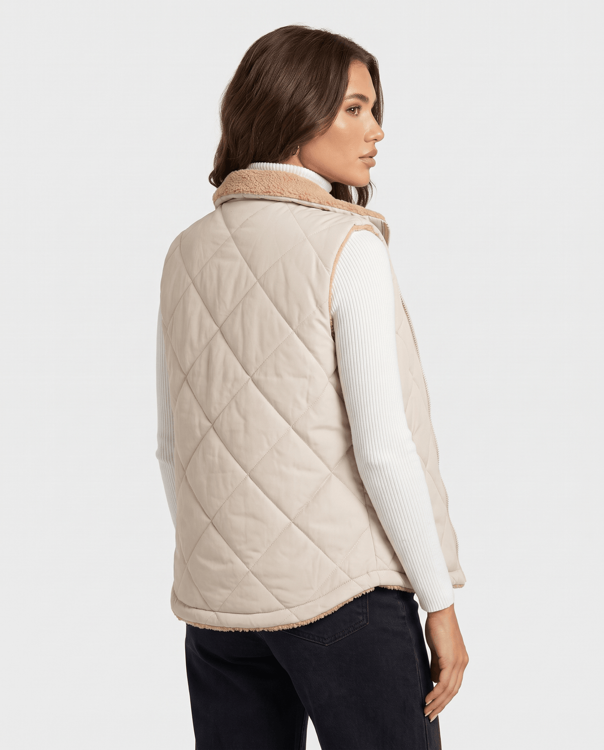Back view of light beige diamond-quilted vest on a model