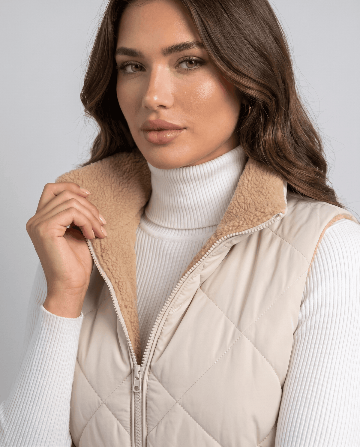 Light beige quilted vest zip and cream sherpa lining shown up close
