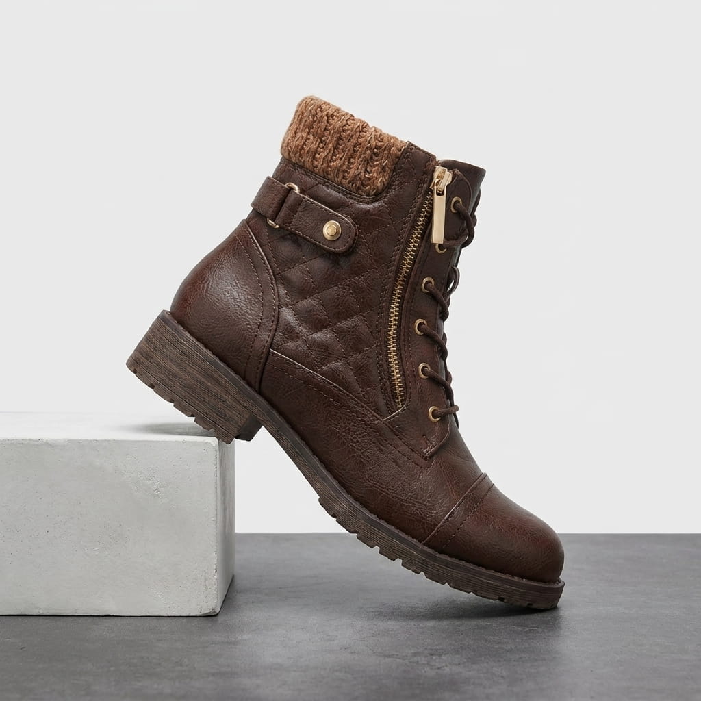 Dark brown quilted vegan leather ankle boot with a knit cuff, diamond stitching, and side zip.