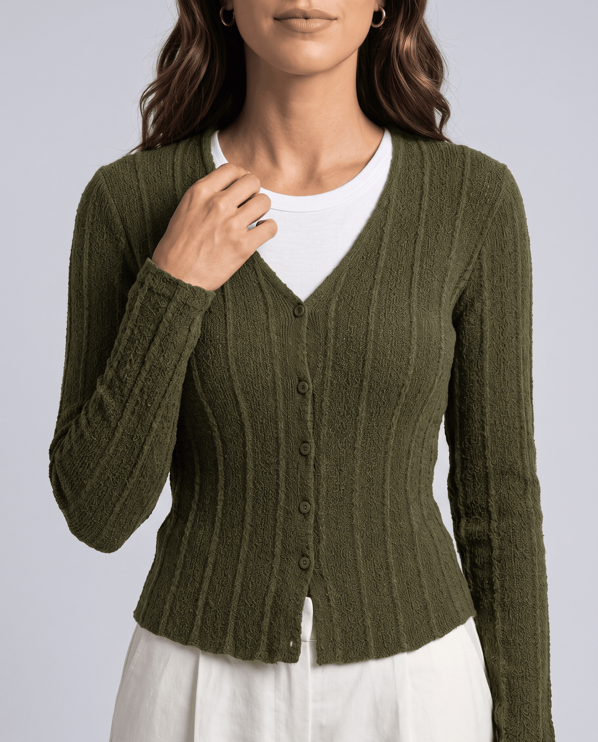 Close view of green ribbed cardigan V neckline and button front