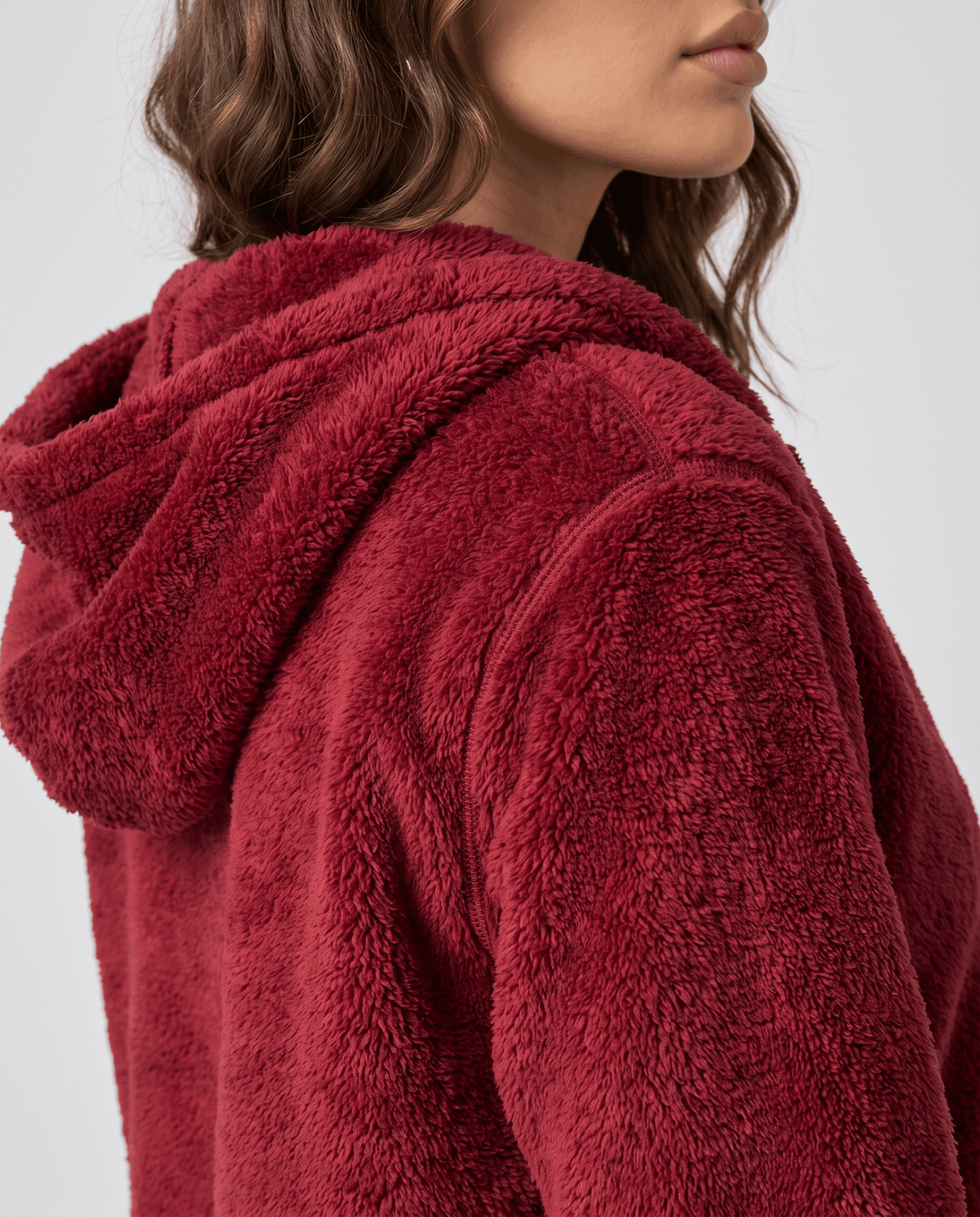 Side close-up of burgundy sherpa hood showing the plush fleece pile