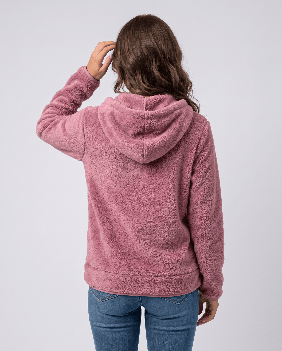 Dusty pink sherpa hoodie from behind with the hood down and a hand on the hair