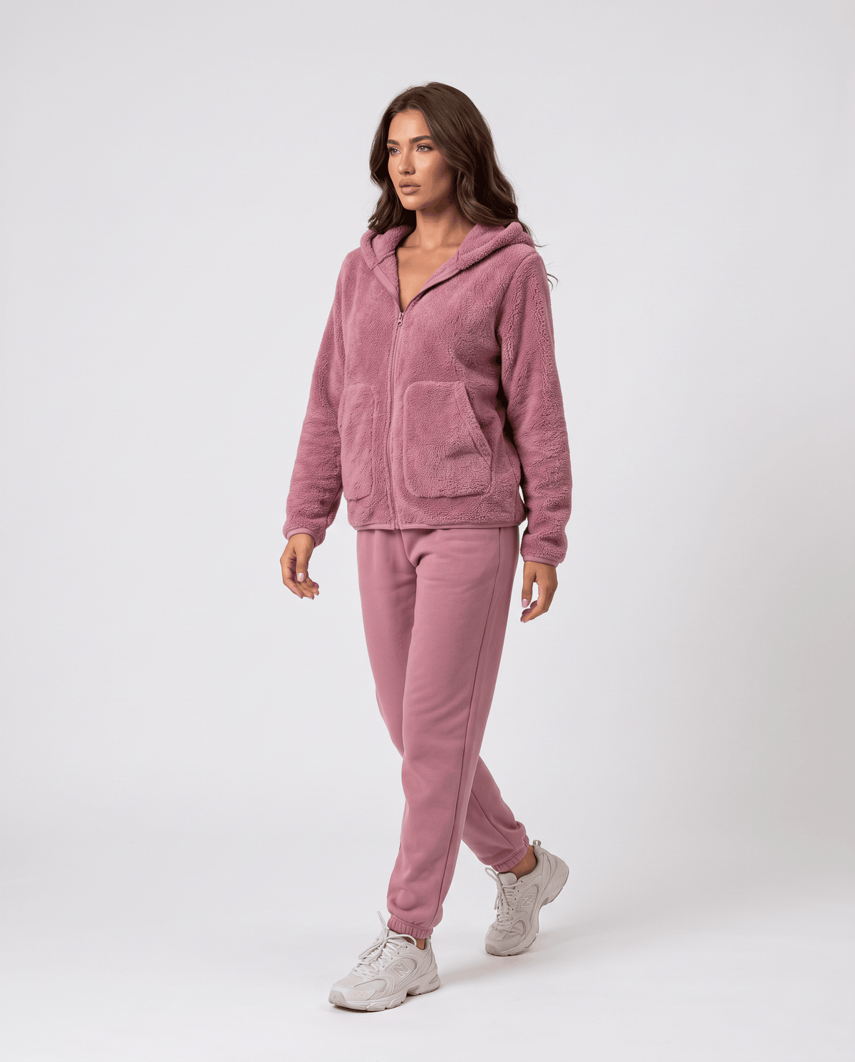 Full-length dusty pink sherpa hoodie worn with matching pink pants and sneakers