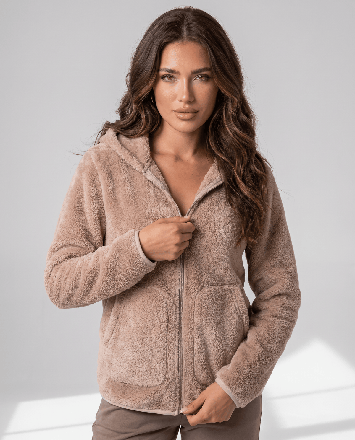 Front view of tan sherpa zip hoodie with a full-length zip and relaxed fit