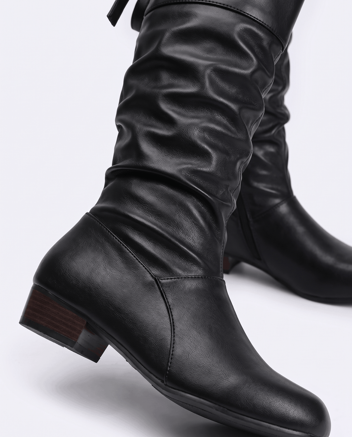 Close-up of the black ruched shaft and low stacked heel
