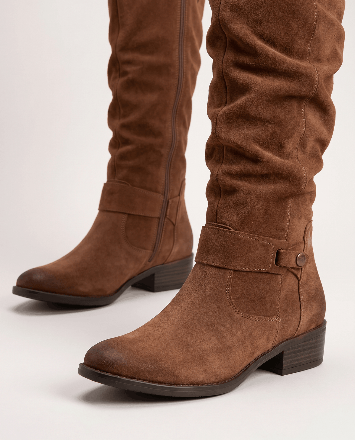 Close-up of the rounded toe, ankle buckle strap and soft brushed suede-look texture