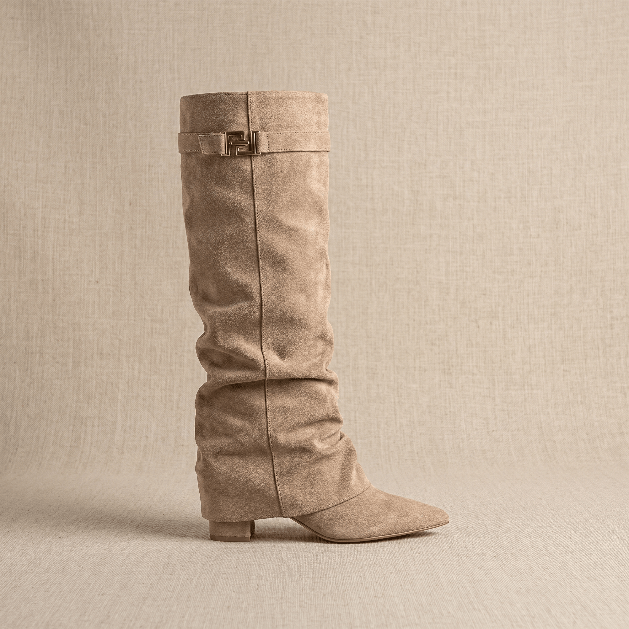 Taupe suede knee-high boots with a fold-over shaft and a pointed toe.