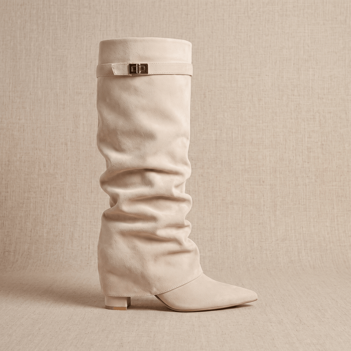 Beige suede knee-high boots with a gathered fold-over shaft and pointed toes.