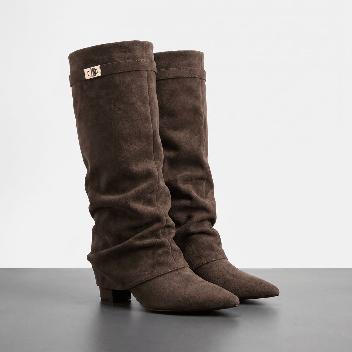 Dark brown suede fold-over knee-high boots with pointed toes and low block heels.
