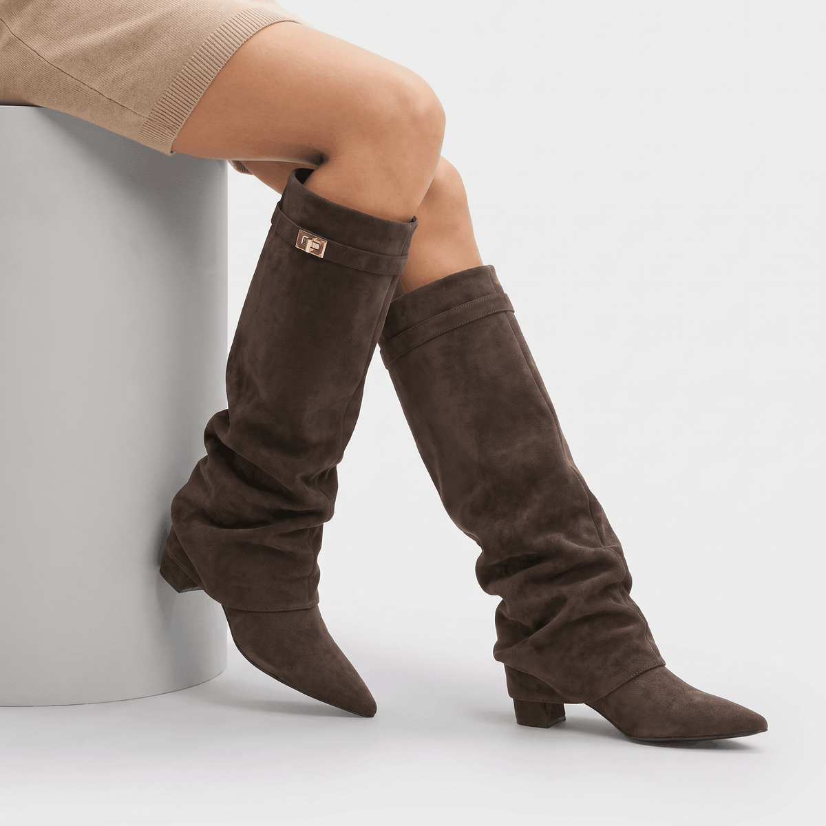 Pair of dark brown suede fold-over knee-high boots with pointed toes and low block heels.
