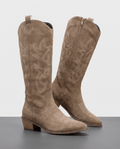 Pair of beige suede-look knee-high cowboy boots with tonal embroidery and stacked heels