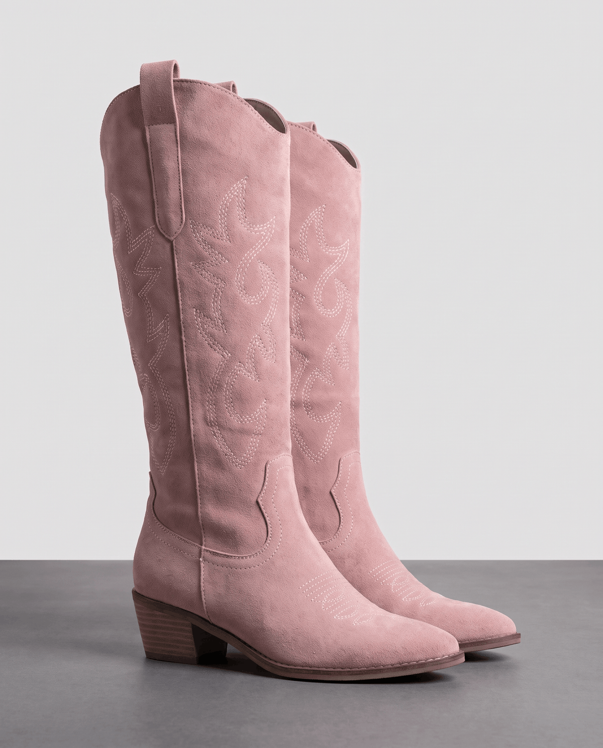Pink embroidered western boots shown as a pair, with pull tabs and stacked heels