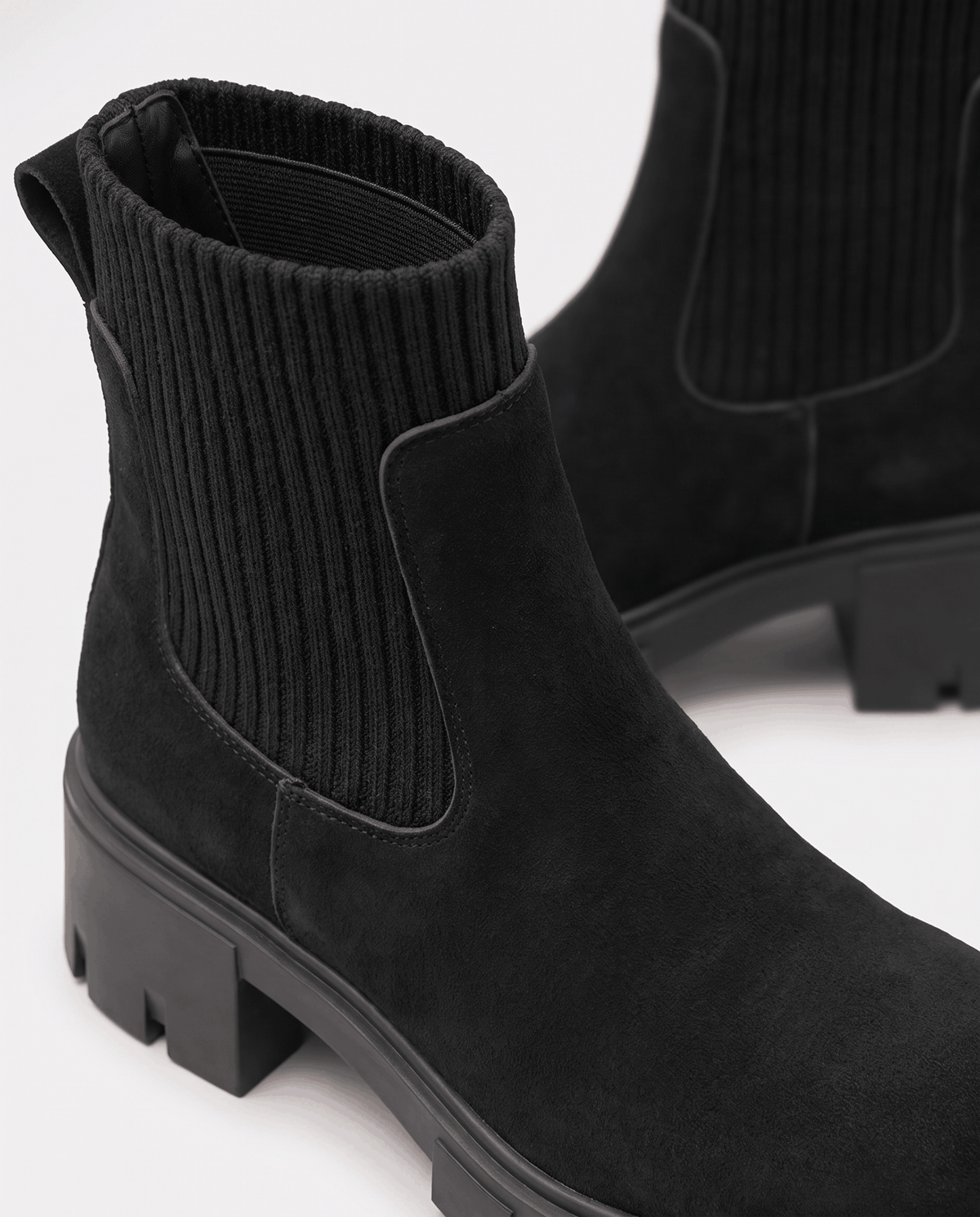 Close-up of black suede upper and lugged rubber outsole
