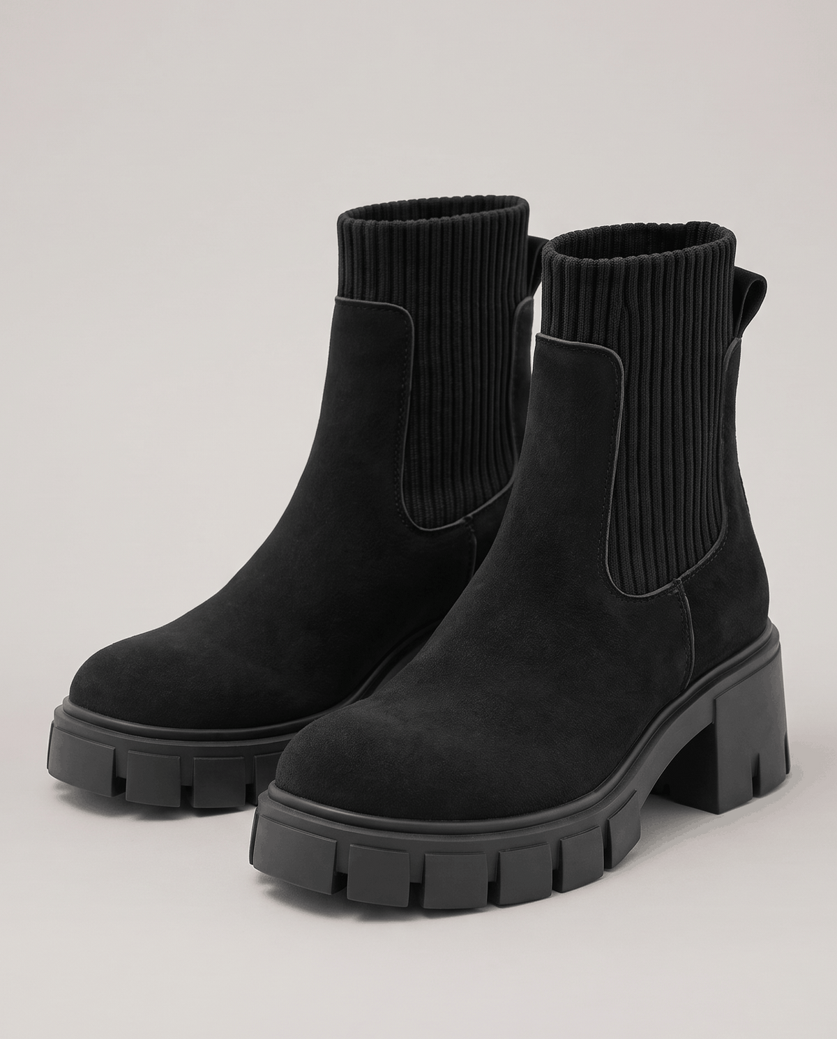Pair of black suede boots with a chunky platform sole