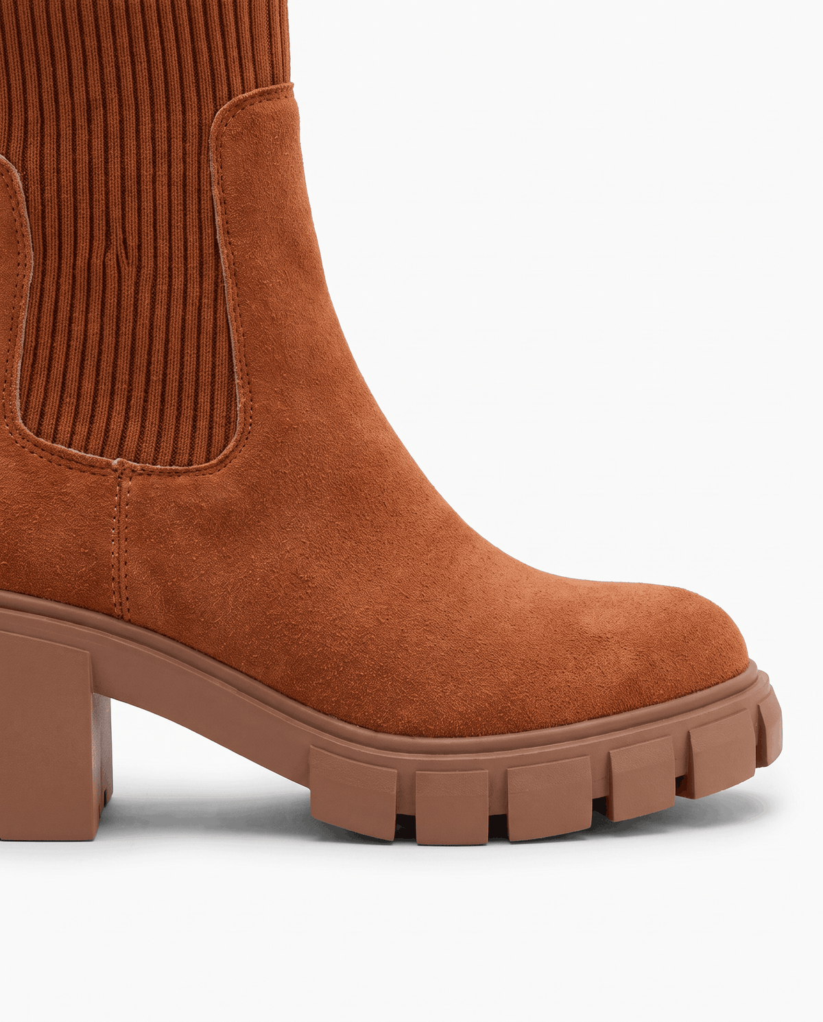 Close-up of brown suede rounded toe and lugged platform sole