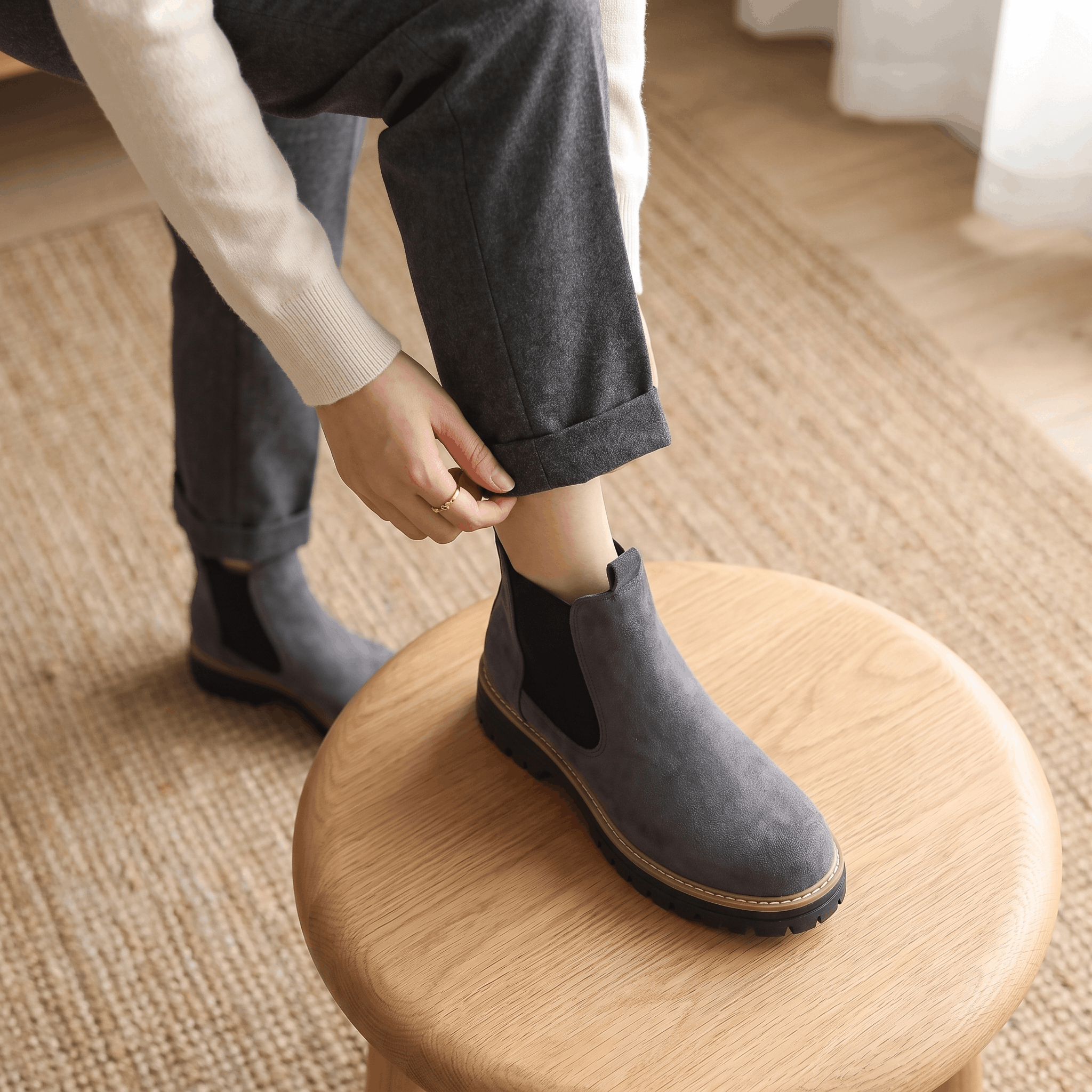 Pair of gray suede Chelsea ankle boots with lug soles displayed on a neutral background.